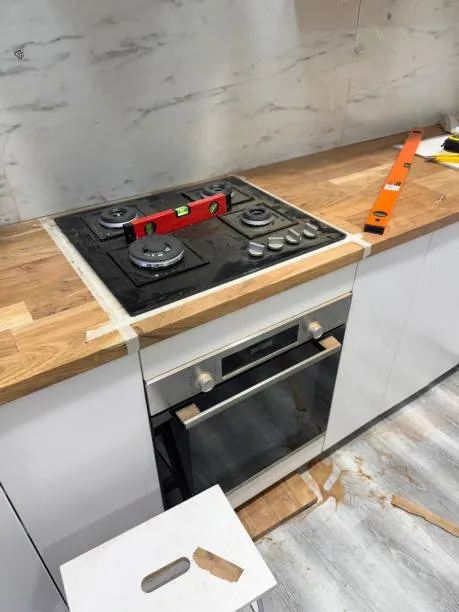 A 10% off all electrician installation services in London & Surrey displays a sleek kitchen renovation, with a modern gas stove as the centerpiece. Enjoy a 10% discount on expert installations, transforming your space into a functional haven.