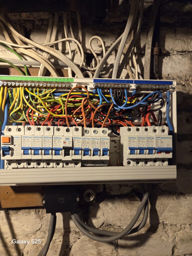 Consumer Unit Inspection During EICR Remedial Works Wimbledon Consumer unit wiring inspected during failed EICR remedial works in Wimbledon showing circuit breakers and electrical connections